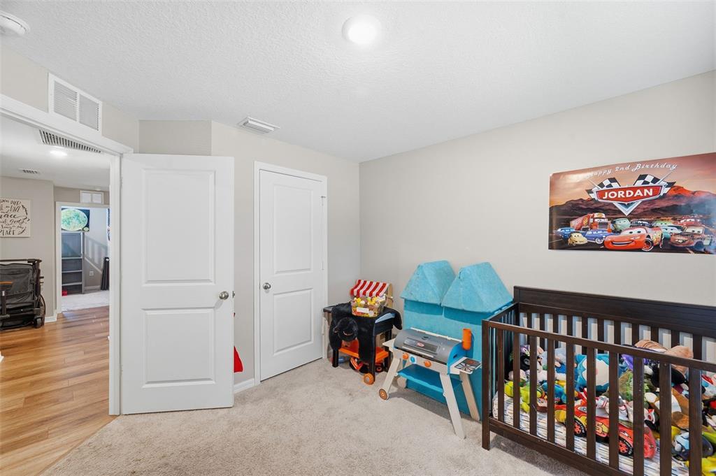 11014 Golden Warbler Road Brooksville, FL 34613 - Photo 21 of 50 a bedroom with furniture entryway and wooden floor