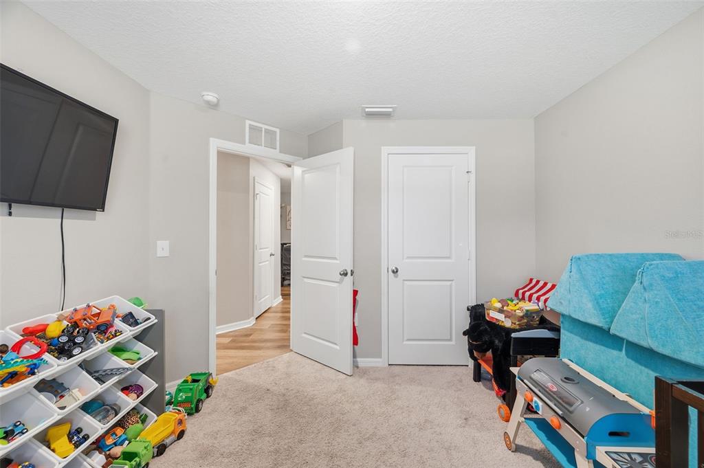 11014 Golden Warbler Road Brooksville, FL 34613 - Photo 22 of 50 a living room with baby toys