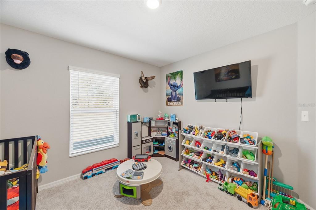 11014 Golden Warbler Road Brooksville, FL 34613 - Photo 23 of 50 a room with toys and a flat screen tv