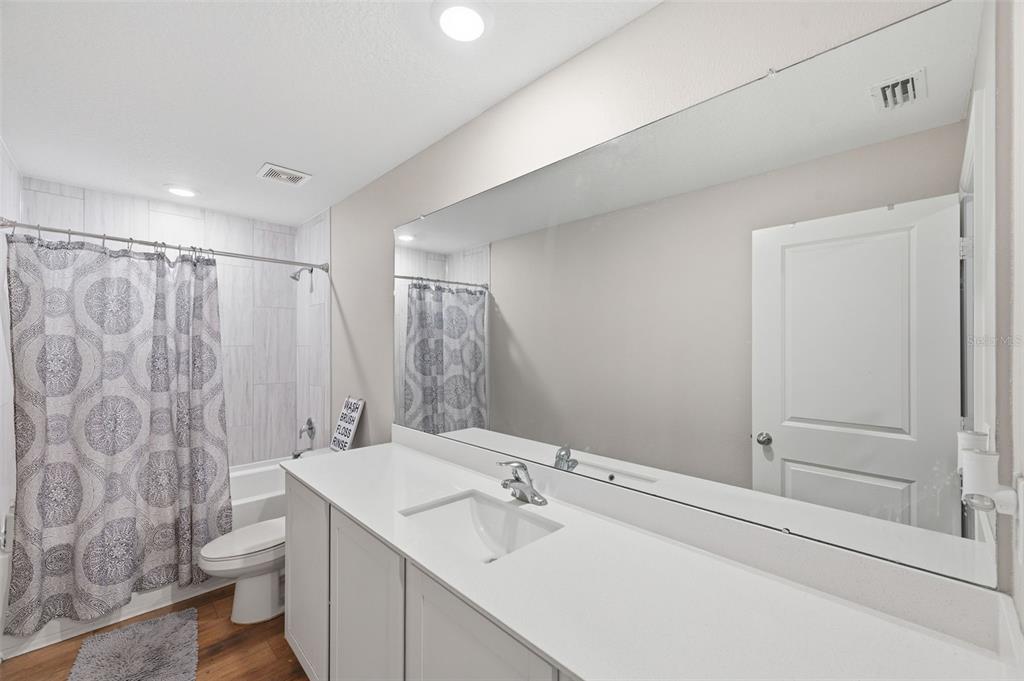 11014 Golden Warbler Road Brooksville, FL 34613 - Photo 30 of 50 a bathroom with a sink a toilet and shower