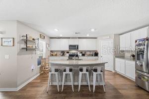 11014 Golden Warbler Road Brooksville, FL 34613 - Photo 3 of 50 a large kitchen with a table and chairs