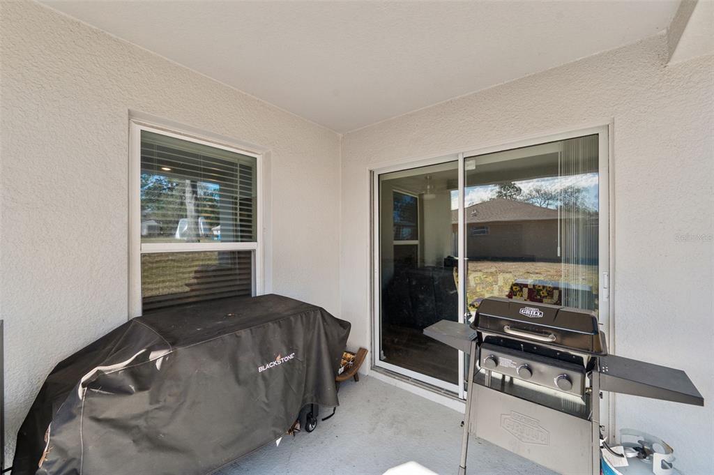 11014 Golden Warbler Road Brooksville, FL 34613 - Photo 34 of 50 a living room with a bed furniture and flat screen tv