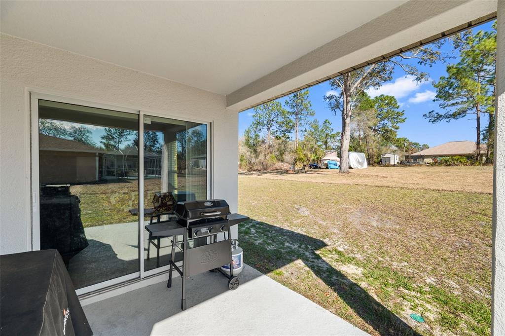 11014 Golden Warbler Road Brooksville, FL 34613 - Photo 35 of 50 a view of a living room with furniture and garden view