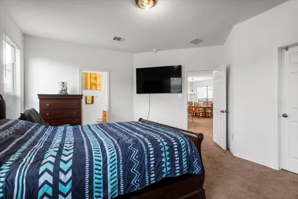 a bedroom with a bed and a flat screen tv