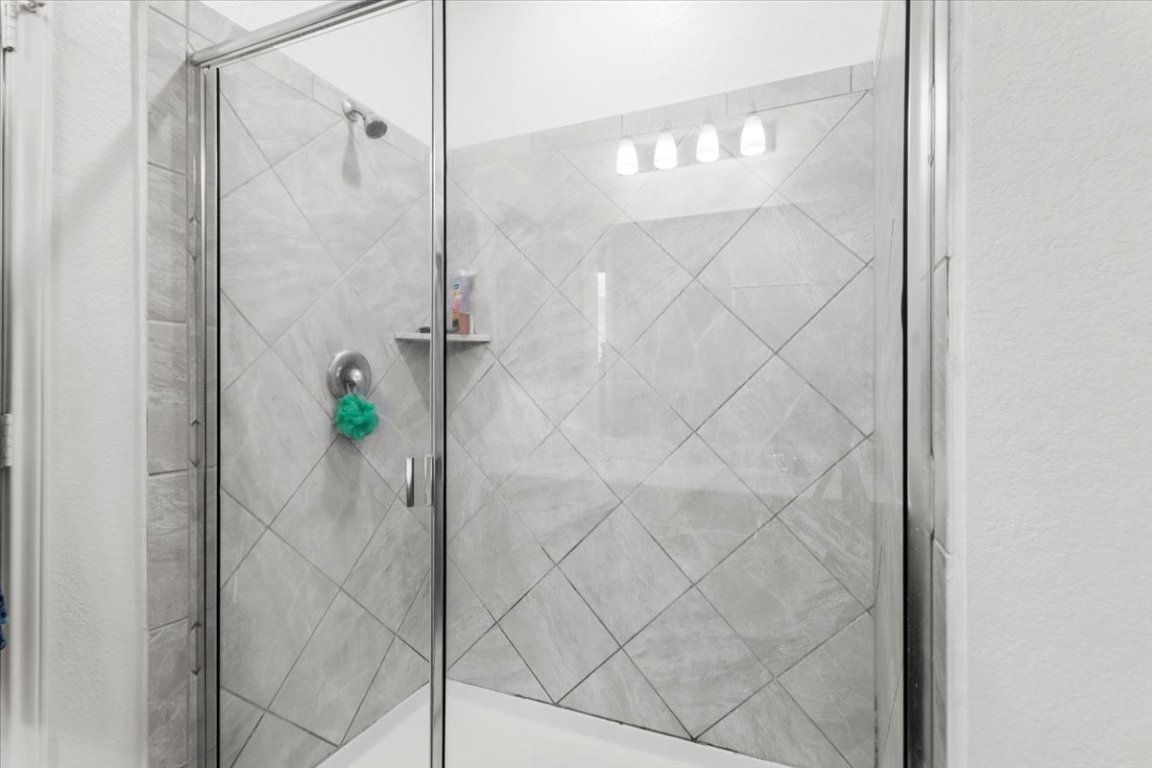 239 Crimson Lane Kyle, TX 78640 - Photo 15 of 25 a bathroom with a shower