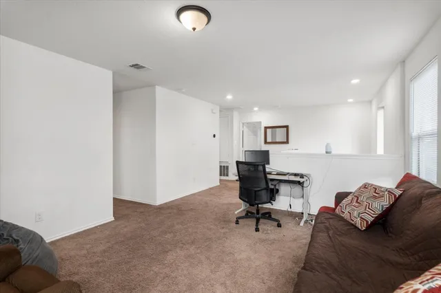 a view of a livingroom with workspace and a couch