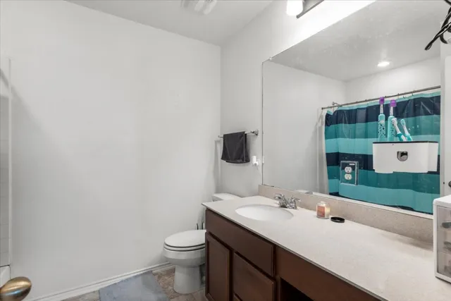 a bathroom with a sink a toilet and mirror