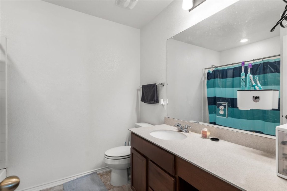 239 Crimson Lane Kyle, TX 78640 - Photo 21 of 25 a bathroom with a sink a toilet and mirror