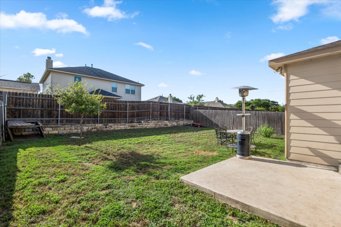 239 Crimson Lane Kyle, TX 78640 - Photo 23 of 25 a view of a house with backyard and a slide