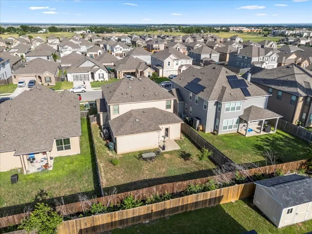 an aerial view of a house with a yard