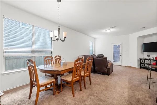 a dining room with furniture and window