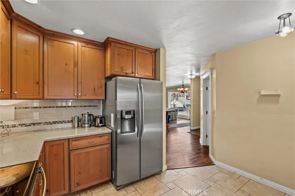 a kitchen with stainless steel appliances granite countertop a refrigerator and a sink