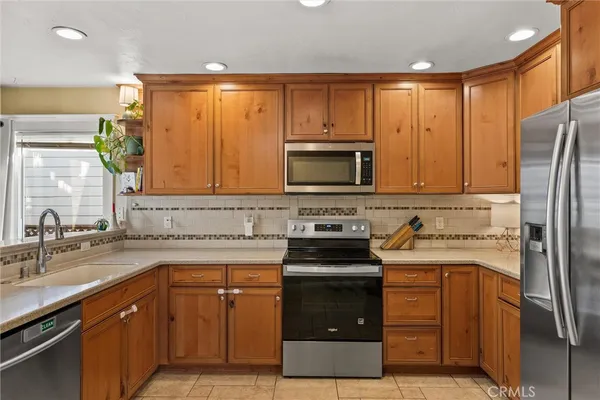 a kitchen with a sink stove and refrigerator