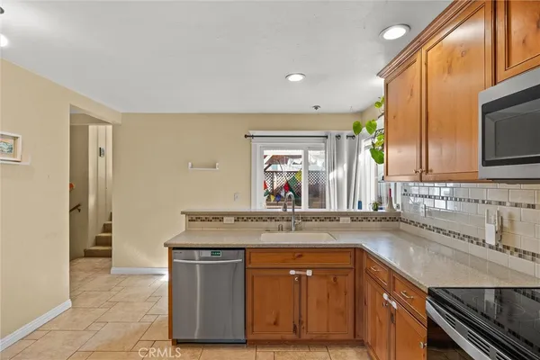 a kitchen with stainless steel appliances granite countertop a sink and a stove