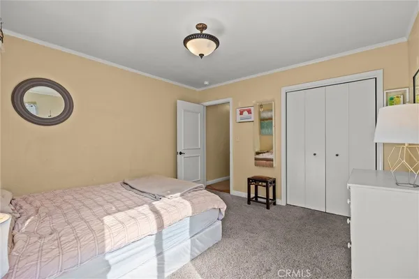 a bedroom with a bed and a lamp