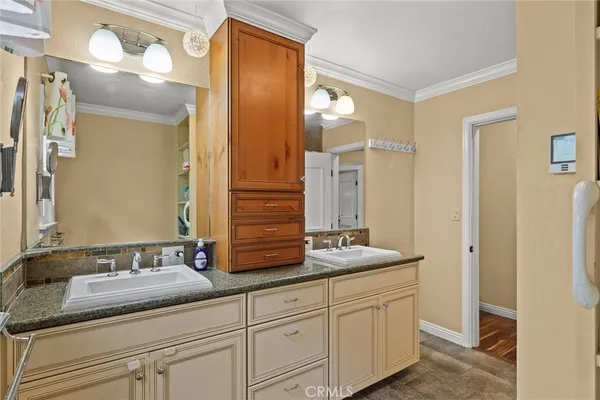 a bathroom with a granite countertop double vanity sink mirror and