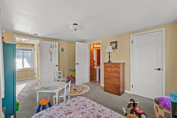 a bedroom with furniture and a window