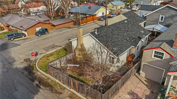 an aerial view of a house with a street