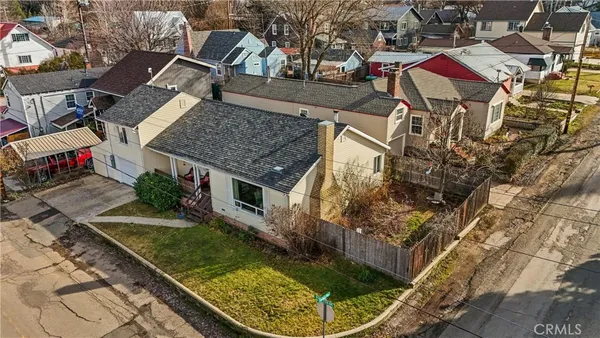 an aerial view of a house with a yard