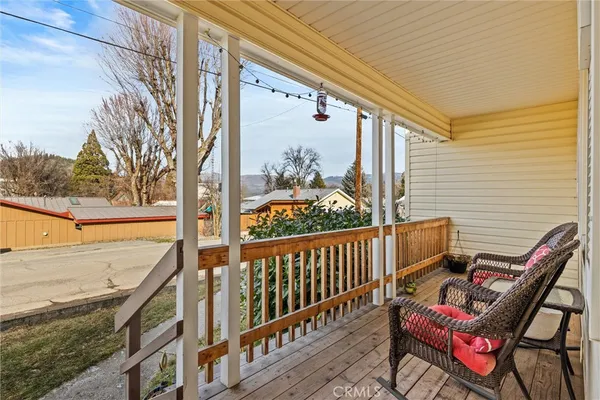 a view of a chairs and table on the balcony