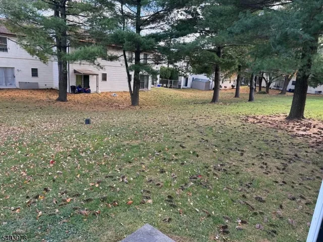 a view of house with backyard