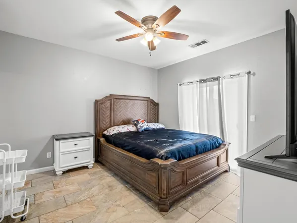 a bedroom with a bed and a window