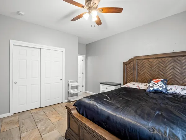 a bedroom with a bed and a chandelier