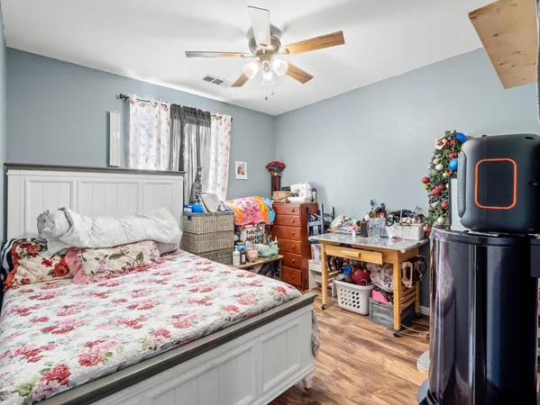 a bedroom with a bed and a chandelier
