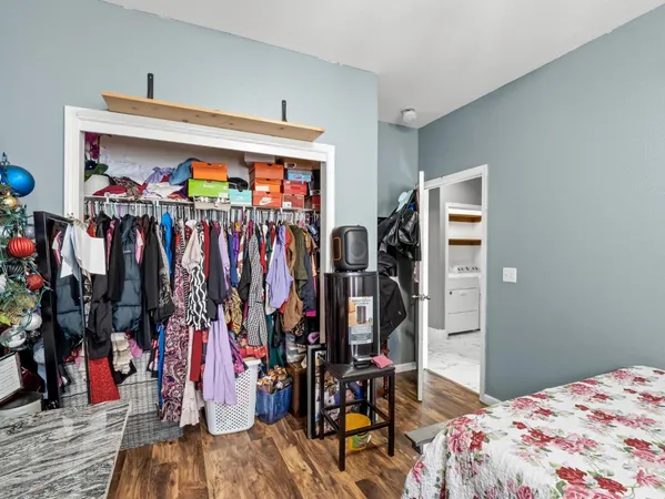 a view of walk in closet with clothes