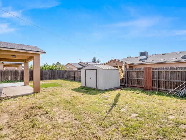 a view of a house with a yard and roof