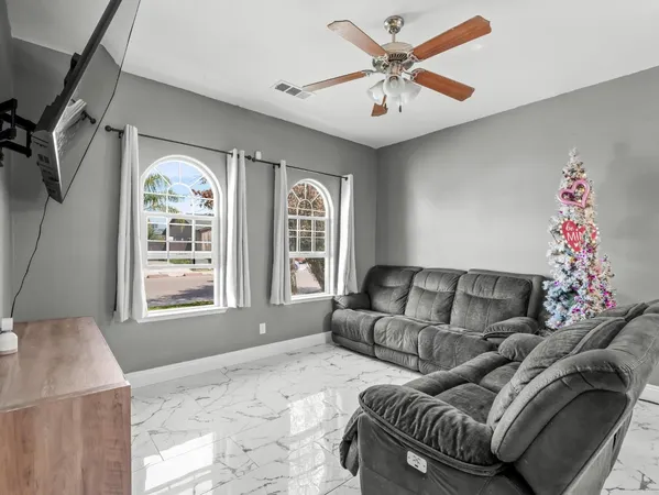 a living room with furniture and a large window