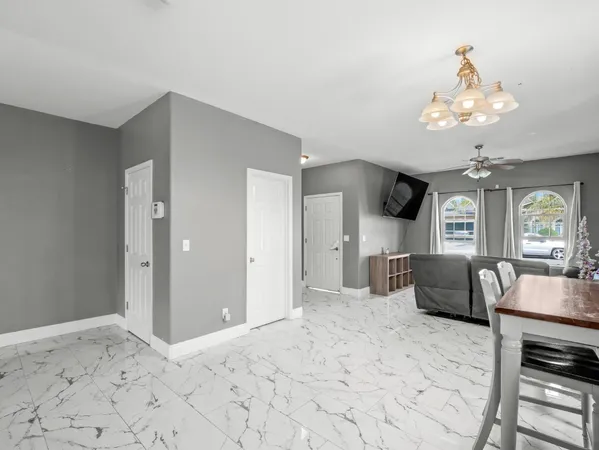 a living room with furniture chandelier and a chandelier