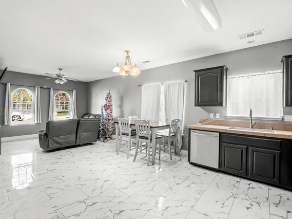 a living room with furniture a dining table and chairs