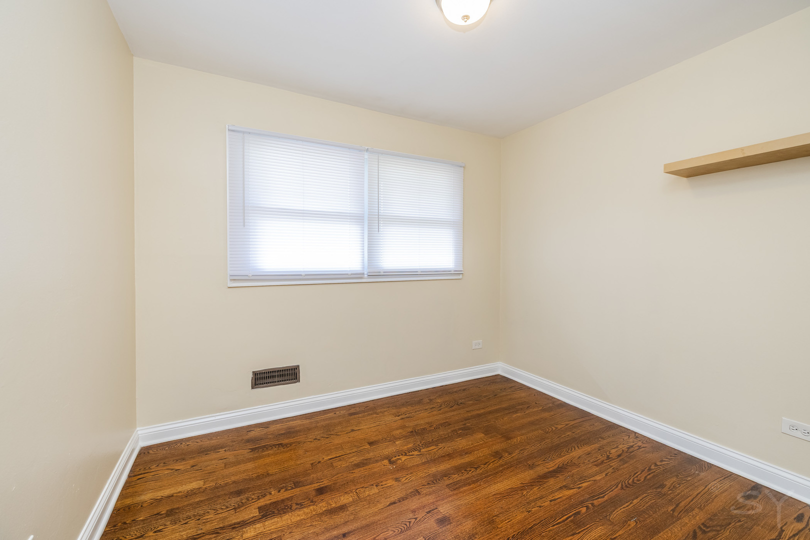 14 Arrowhead Drive Thornton, IL 60476 - Photo 9 of 26 an empty room with wooden floor and windows