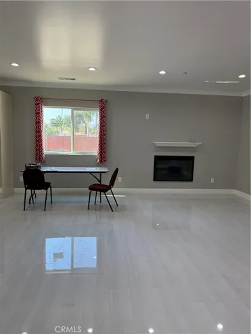 a living room with furniture a large window and a fireplace