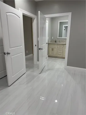 wooden floor with white cabinets and wooden floor