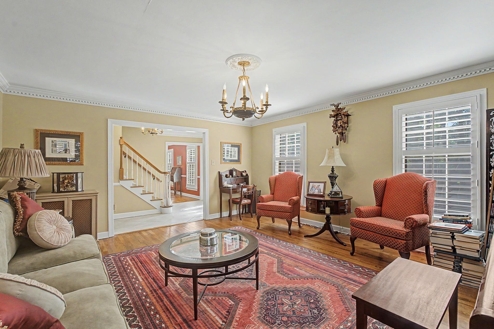 1929 Miller Farms Road Germantown, TN 38138 - Photo 6 of 40 Living room featuring hardwood flooring, crown molding, a decorative ceiling medallion, and plantation shutters