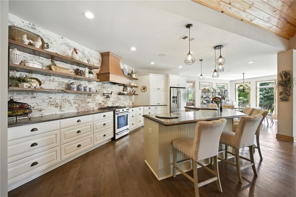 1620 Pond Fork Church Road Talmo, GA 30575 - Photo 18 of 73 a kitchen with stainless steel appliances kitchen island granite countertop a sink and cabinets