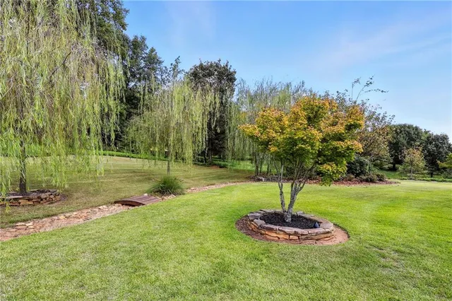 a view of a pathway with a wrought fence
