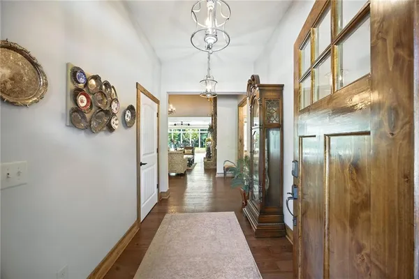 a dining room with livingroom view and wooden floor