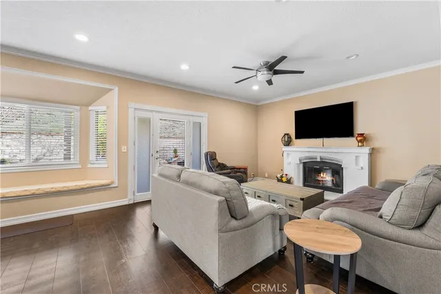 a living room with furniture a fireplace and a flat screen tv