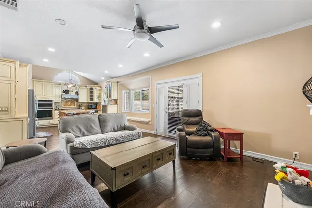 a living room with furniture ceiling fan and a rug