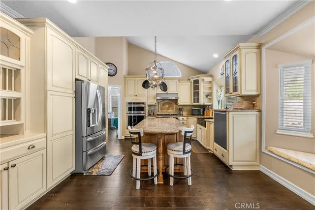 a kitchen with stainless steel appliances granite countertop a refrigerator and microwave