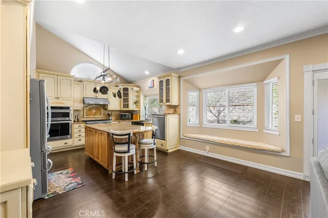a view of a kitchen with furniture and wooden floor