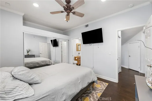 a bedroom with a large bed and a flat screen tv