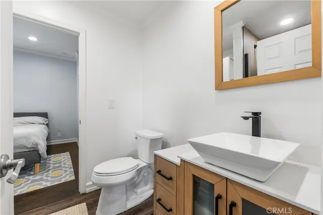 a bathroom with a sink a toilet and mirror