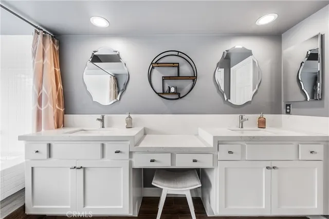 a bathroom with a double vanity sink mirror and