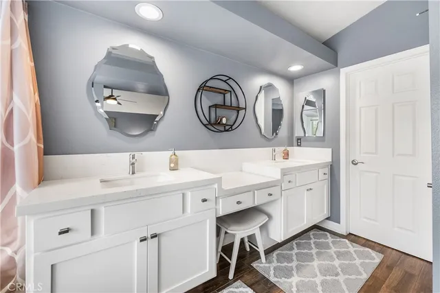 a spacious bathroom with a double vanity sink and a mirror