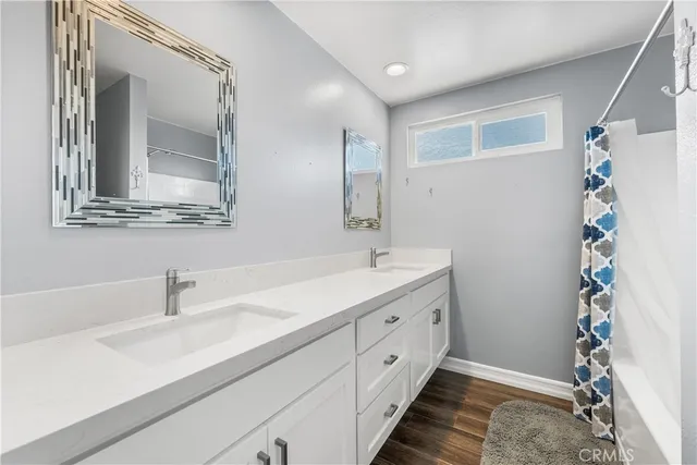 a bathroom with a double vanity sink mirror and