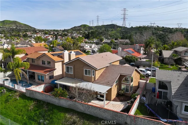 an aerial view of a house with a garden and lake view